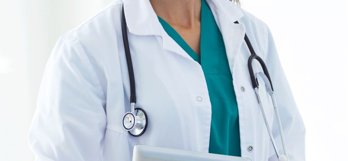 Beautiful young female doctor looking at camera in the office.